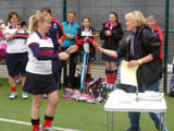 A woman being handed an award